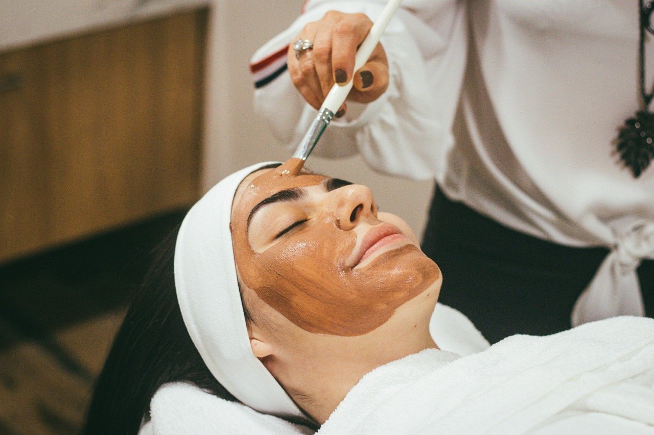 woman getting mud mask in spa Large