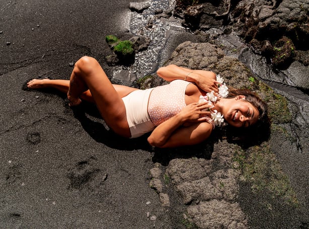 woman-in-swimsuit-lying-in-beach-sand
